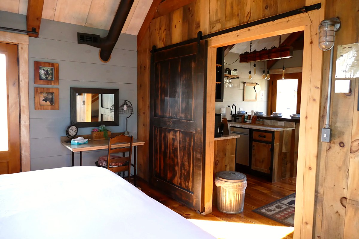 View through the handcrafted barn door into the kitchen