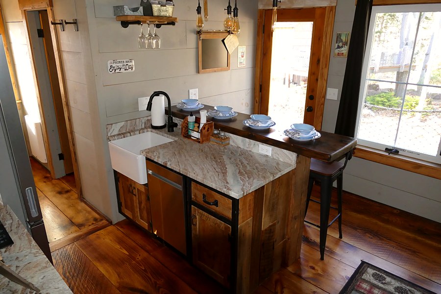 Kitchen island with farmhouse sink and handcrafted cabinetry